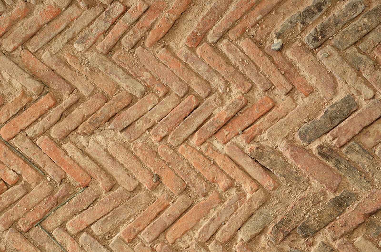 Détail du fond de l'aqueduc en opus spicatum: dallettes posées sur la tranche et en épi. Photo P. Lutz