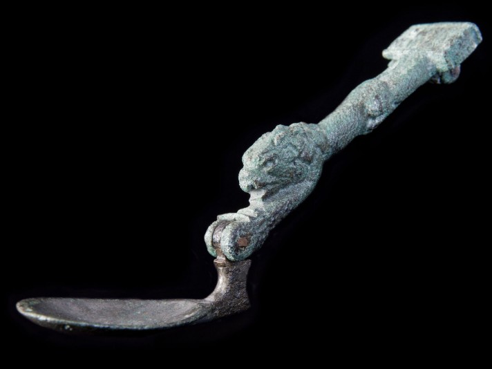 Couteau-cuillère pliable en bronze dont le manche illustre un lion © Site et Musée romains d'Avenches, photo NVP3D